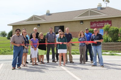 Monona Barb Collins cuts the ribbon for the new aquatic center parking lot